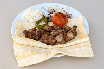 Beef steak grill with rice pilaf, fried potatoes, grilled pepper and tomatoes.Mix Platter with Beef rips, Cutlets, Potatoes and Sauces.