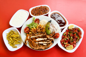 Beef steak grill with rice pilaf, fried potatoes, grilled pepper and tomatoes.Mix Platter with Beef rips, Cutlets, Potatoes and Sauces.
