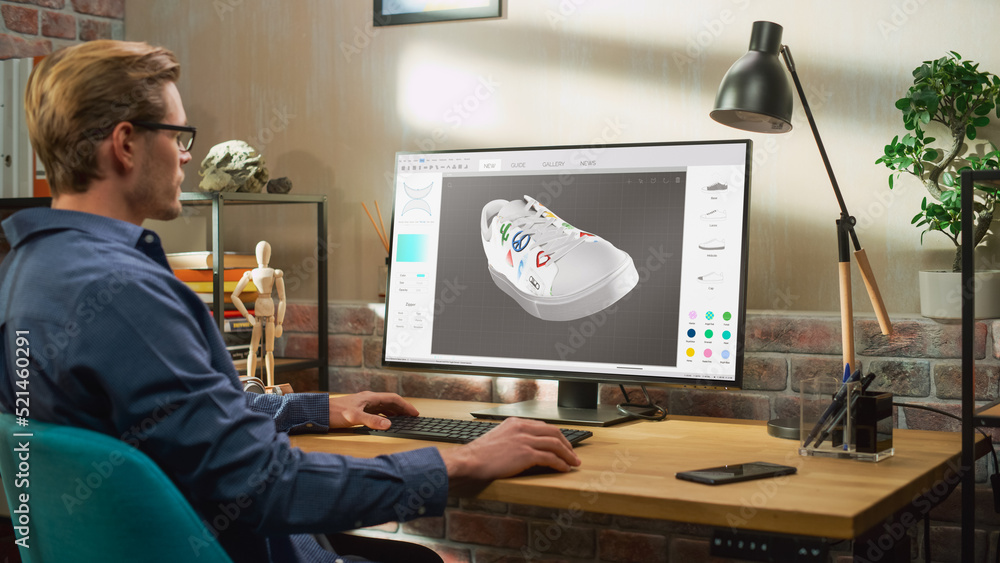 Poster Young Male Footwear Designer Works on 3d Model of Shoe and Change Colours on It While Working on Desktop Computer in Creative Space. Shoe Production Procedure Concept.