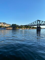 Frankfurt, Germany: River view of The Eiserner Steg. The Eiserner Steg is a pedestrian bridge in Frankfurt am Main built in 1868. City skyline in Frankfurt, Germany.