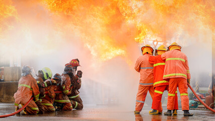 Fireman,Firefighter training Firefighters using water and fire extinguishers to fight the flames in emergency situations. in a dangerous situation All firefighters wear firefighter uniforms for safety