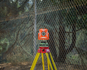 An orange and white transit level sits atop a yellow and red tripod at Lake Hollywood in Los...