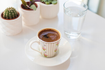 a cup of Turkish coffee and water 