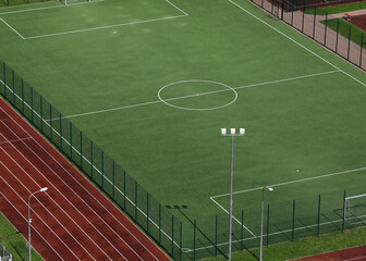 Football green field close up, top view, tennis court without people.