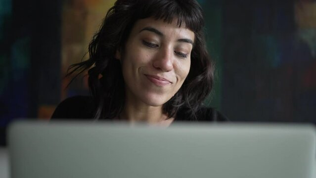 Woman having a creative idea eureka moment. South American girl having breakthrough idea in front of laptop computer