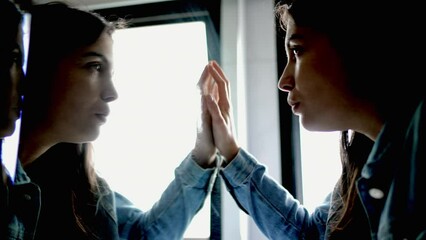 Woman looking at mirror reflection facing your fears concept