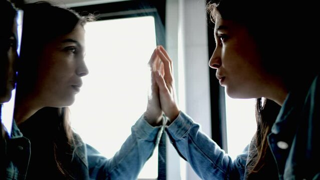 Woman looking at mirror reflection facing your fears concept