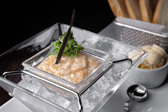 Pike caviar in ice with toas. selective focus