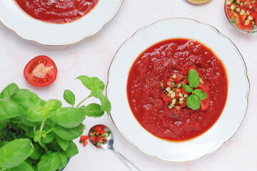 Plates with traditional gazpacho tomato soup