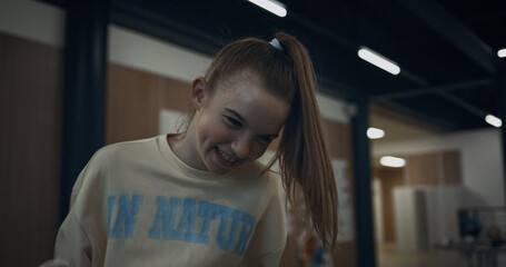 Happy school girl playing table foosball closeup. Teen child win in soccer game.