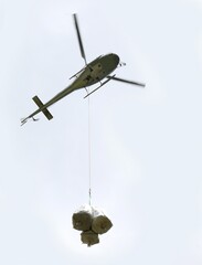 helicopter that flies carrying very large bags of material to inaccessible areas not reachable