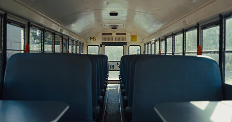 Empty seats placed school bus interior closeup. Safety transport concept.