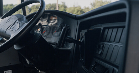 Closeup steering wheel dashboard in driver cabin. Safety transport interior.