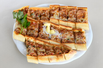 Turkish pita with minced cubed meat and cheese (Turkish name: Kiyma Kusbasi kasarli pide)