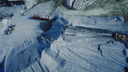 Aerial view of big career with excavators and trucks at work, heavy industry and extraction of...