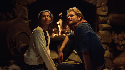 Obraz na płótnie Canvas Boyfriend girlfriend sitting fireplace on evening date. Couple talk together.
