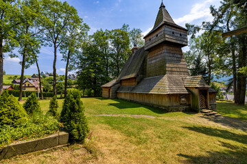 Old orthodox church surrounded by the trees on the hill at clear day.