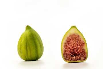 Ripe green figs and a sliced half on white background, clipping paths included
