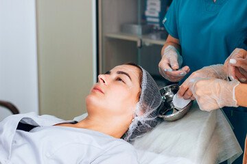 Kharkiv, Kharkiv Oblast, Ukraine - 08 18 2021: Training of the master doctor cosmetologist practice of Injection of botox, pencil marking of the forehead