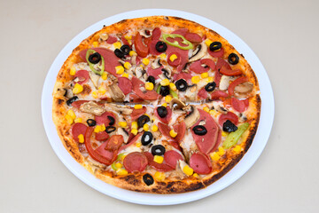 Fototapeta na wymiar Delicious mixed pizza with rich content. Menu concept of choice and diversity