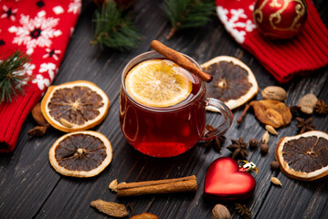 Fruity mulled wine on a wooden background with spices.