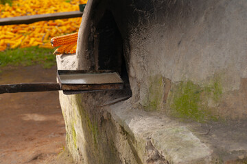 Insert trays of artisan bread into a handmade oven.