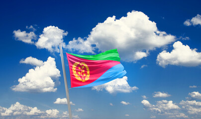 Eritrea national flag cloth fabric waving on the sky - Image