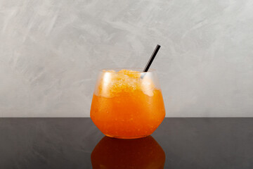 Glass of Orange Granizado. Traditional Spanish summer iced drink. Slushie fruit drink. Sweet Shaved...