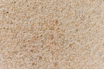 The texture of the stone is beige.Decorative stone or concrete. Rough texture. Uneven surface.Abstract background.