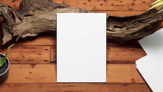 Mockup white paper on the old tree trunk,wooden brown table background with tropical house plants ,top view. zoom out