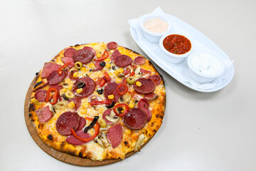 Delicious mixed pizza with rich content. Menu concept of choice and diversity