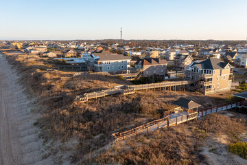 Aerial View of dunes beach access and vacation homes in Nags Head during golden hour