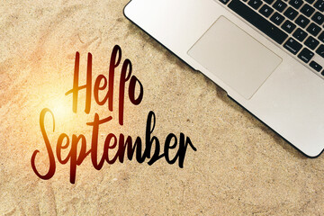 laptop on sand with hello September concept © hadjanebia
