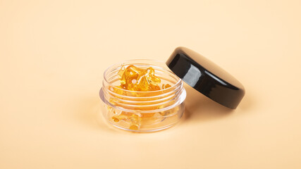 golden cannabis resin wax in a box, strong thc extract.