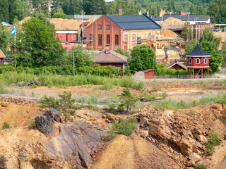 Fototapeta premium Falun Copper Mine the World Heritage with orange mountain visible and tourist spot in background.