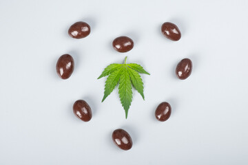 chocolate candy with thc and heart with green leaf ,cannabis recreational sweet drugs.