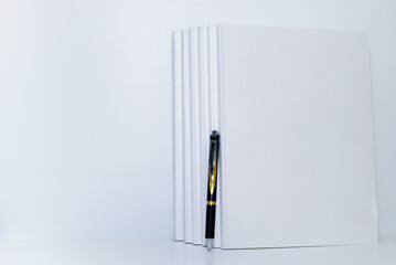notebook and pen on white background