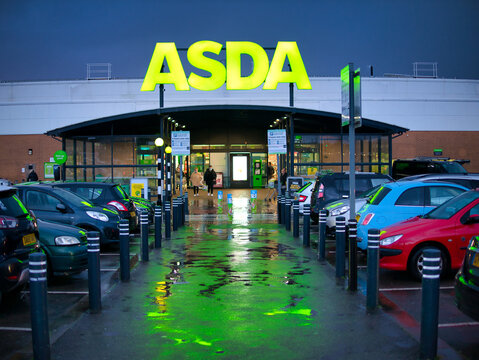 The car park and frontage of the a store of the ASDA British supermarket chain, located in a residential area in the North of England. Taken in late afternoon after rain.