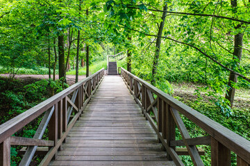 Fototapeta na wymiar Wooden bridge leading to the Vytautas Hill, Birstonas, Lithuania