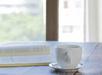 book on the table with cup of coffee