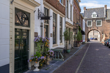 Small street with the Culemborgse Poort or Huizenpoort in the picturesque Dutch fortified town of Buren in the province of Gelderland.
