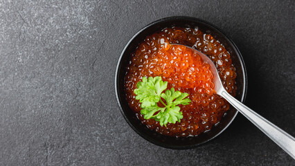 Red salmon caviar with parsley in a bowl