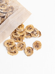 Banana chips in zip package on white background. Dried bananas. Packaging, storage and sale of dried fruits