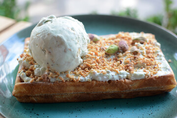 Belgian waffle with ice cream and pistachios
