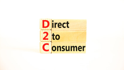 D2C direct to consumer symbol. Concept words D2C direct to consumer on wooden blocks on a beautiful white table white background. Business and D2C direct to consumer concept. Copy space.