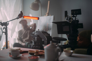 Professional cinema and video camera on the set. Shooting shift, lighting fixtures, shooting equipment and the team.