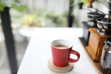 Red coffee cup on white table