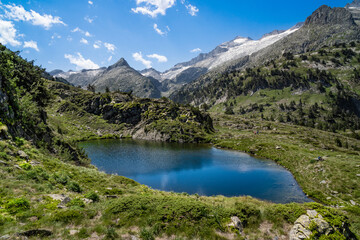 Naklejka na ściany i meble Spectacular, wonderful and evocative landscape of a lake in the Pyrenees surrounded by mountains and snow-capped peaks of Benasque. In HDR color.