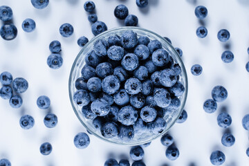 Blueberry with water drops. Blue berries in glass plate on white background. Many natural organic...