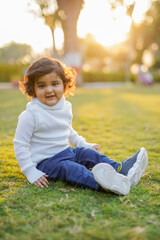 Little boy playing on grass.